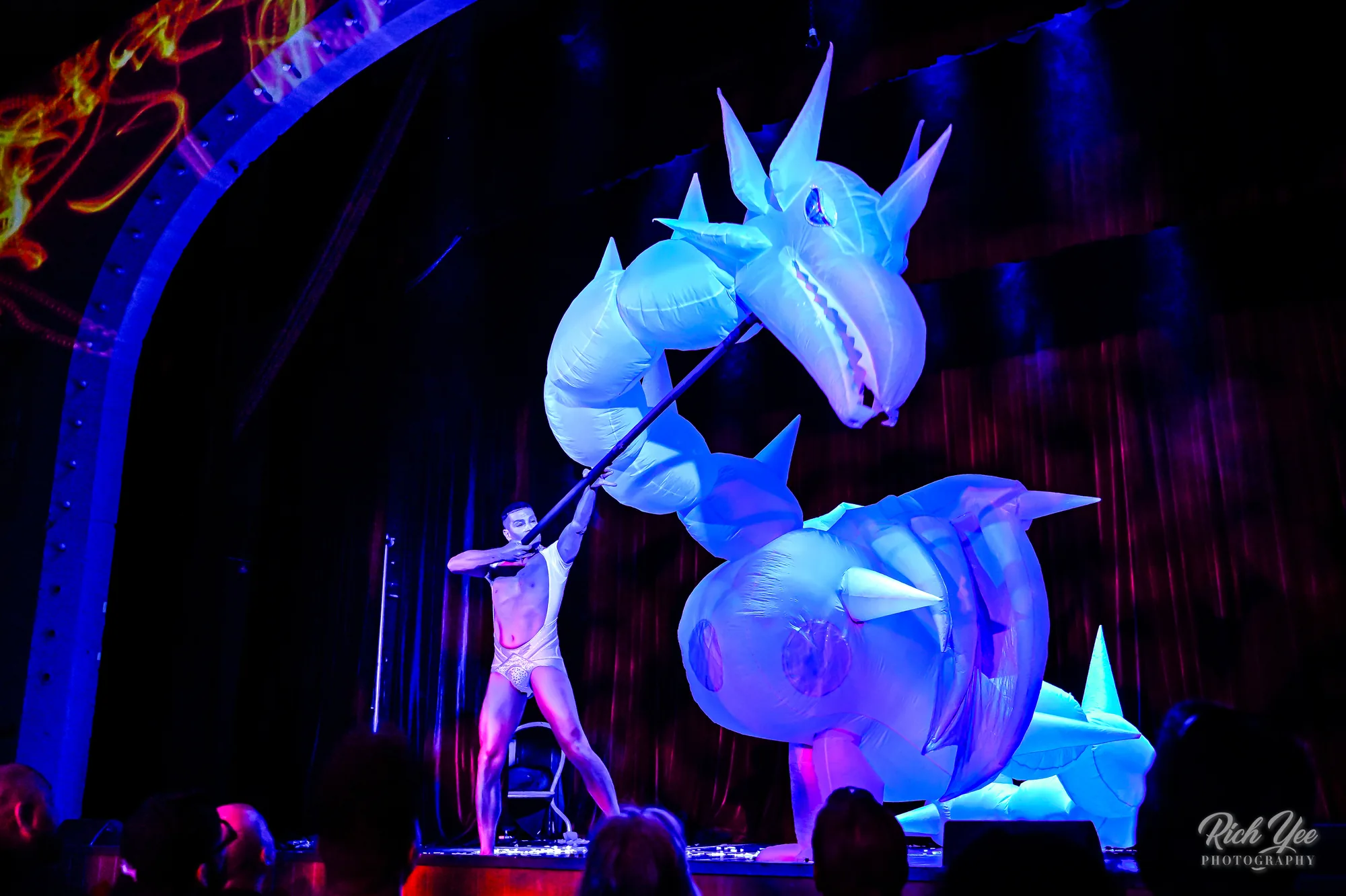 Performer with glowing inflatable dragon puppet